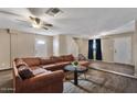 A large, comfortable sectional sits in the living room, with wood-look floors and access to other areas at 8328 W Fairmount Ave, Phoenix, AZ 85037