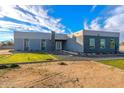 Modern home with gray brick and white accents, spacious yard at 10226 N 171St Dr, Waddell, AZ 85355