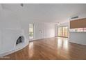 Living room with hardwood floors and a fireplace, showcasing a bright and open space at 10426 N 11Th St # 3, Phoenix, AZ 85020