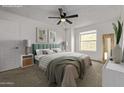 Relaxing main bedroom boasts a modern ceiling fan, comfortable carpet, and natural light at 10426 N 11Th St # 3, Phoenix, AZ 85020