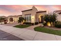 Tan colored stucco home with a lush green lawn at 1175 E Copper Holw, Queen Creek, AZ 85140