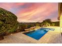 Inviting rectangular pool with a waterfall feature in the backyard at 1175 E Copper Holw, Queen Creek, AZ 85140