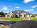 Stunning single Gathering home features a well-manicured lawn, circle drive, and beautiful traditional architecture at 1233 E Salado Cir, Mesa, AZ 85203