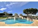 Backyard swimming pool with slide, spa, and lush landscaping creating a relaxing outdoor oasis at 1233 E Salado Cir, Mesa, AZ 85203