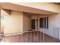 Covered patio entryway with tile flooring and wrought iron railing at 12821 W Whitton Ave, Avondale, AZ 85392