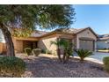 Front yard view of a single-story house with a two-car garage at 12821 W Whitton Ave, Avondale, AZ 85392