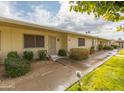 Front view of a light beige single-story building with landscaping and walkways at 13227 N 110Th Ave, Sun City, AZ 85351