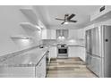 Modern kitchen with stainless steel appliances and granite countertops at 13227 N 110Th Ave, Sun City, AZ 85351