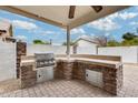 Built-in outdoor kitchen with stainless steel appliances at 13778 W Cambridge Ave, Goodyear, AZ 85395