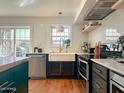 Modern kitchen with white cabinets, farmhouse sink, and stainless steel appliances at 1425 E Desert Cove Ave # 24, Phoenix, AZ 85020