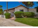 Well-kept single-story home with tile roof, gated entry, and inviting green lawn at 15240 N 51St St, Scottsdale, AZ 85254