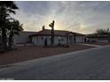 Ranch-style home with red tile roof and mature desert landscaping at 15880 S Warren Pl, Arizona City, AZ 85123