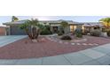 Single-story home with desert landscaping, and a two-car garage at 21806 N Aztec Ct, Sun City West, AZ 85375