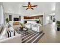 Open living area with modern furniture and a kitchen island at 22794 E Via Las Brisas --, Queen Creek, AZ 85142