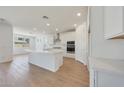 Stylish kitchen featuring stainless appliances, quartz counters, white cabinetry, and an open concept design at 23048 E Watford Dr, Queen Creek, AZ 85142