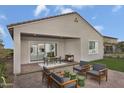 Covered patio with seating area and a view of the grassy backyard at 24241 W Agora Ln, Buckeye, AZ 85326