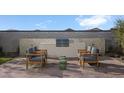 Outdoor kitchen area with built-in grill and seating for relaxing at 24241 W Agora Ln, Buckeye, AZ 85326