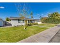 Updated mid-century modern home with a spacious lawn and walkway at 4302 E Whitton Ave, Phoenix, AZ 85018