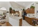 Bright kitchen with wood cabinets and tile floors at 563 W Champagne Dr, Chandler, AZ 85248
