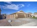 House exterior with a large driveway, double-door garage, and gated entry at 7318 W Jones Ave, Phoenix, AZ 85043