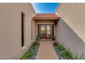 Brick pathway leads to double doors entry with tile flooring at 7785 E Luke Ln, Scottsdale, AZ 85250