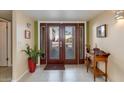 Interior entryway with double doors, tile floor, and small table at 7785 E Luke Ln, Scottsdale, AZ 85250