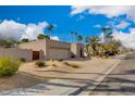 Front view of a house with palm trees and a driveway at 7785 E Luke Ln, Scottsdale, AZ 85250