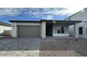 Charming single-story home with a two-car garage and desert landscaping at 11453 E Utah Ave, Mesa, AZ 85212