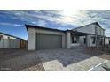 Exterior view of home showing the garage, entryway and desert landscaping at 11453 E Utah Ave, Mesa, AZ 85212