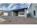 A modern single-Gathering home featuring desert landscaping and a covered entryway at 11453 E Utah Ave, Mesa, AZ 85212