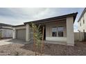 Inviting single-story home with desert landscaping and a covered front porch at 11453 E Utah Ave, Mesa, AZ 85212