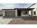 Charming single-story home featuring a 2-car garage and low maintenance desert landscaping at 11453 E Utah Ave, Mesa, AZ 85212