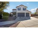 Two-story home with a three-car garage and landscaped yard at 12053 N 157Th Ave, Surprise, AZ 85379