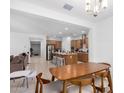 Open concept dining area with wood table and chairs, overlooking the kitchen at 12105 W Luxton Ln, Avondale, AZ 85323