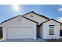 Newly constructed home with white exterior, brown roof, and a two-car garage at 13165 E Verbina Ln, Florence, AZ 85132