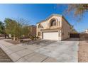 Two-story house with a white garage door and landscaping at 1340 S 232Nd Ave, Buckeye, AZ 85326