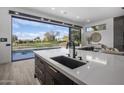 Modern kitchen with expansive view; features large island and sink at 17444 N 79Th St, Scottsdale, AZ 85255