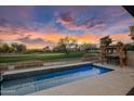 Luxury pool with golf course view at sunset at 17444 N 79Th St, Scottsdale, AZ 85255