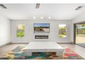 Modern living room featuring a fireplace and large TV at 17925 W Mauna Loa Ln, Surprise, AZ 85388