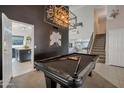 Pool table in a stylish game room with dark walls and modern lighting at 1931 W Mulberry Dr, Chandler, AZ 85286