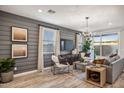 Beautiful living room featuring shiplap walls, modern decor, lots of natural light, and an open floor plan at 21048 N 58Th St, Phoenix, AZ 85054