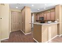 Kitchen entry with light brown cabinets and wood floors at 2331 W Kristina Ave, San Tan Valley, AZ 85144