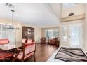 Elegant dining room with a wooden table, chairs, and hardwood floors at 2551 E Saratoga St, Gilbert, AZ 85296