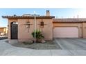 Charming single-story home featuring desert landscaping, tile roof, private drive, and an attached two-car garage at 4511 W Valencia Dr, Laveen, AZ 85339