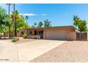 Single-story home with a two-car garage and landscaped yard at 4543 W Lane Ave, Glendale, AZ 85301