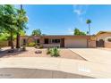 Single-story home with a two-car garage and landscaped yard at 4543 W Lane Ave, Glendale, AZ 85301