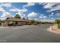 Exterior view of a community of condos with a paved road and neatly kept landscaping at 520 S Greenfield Rd # 20, Mesa, AZ 85206