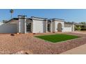 Newly remodeled single story home with artificial turf and rock landscaping at 5919 S Lakeshore Dr, Tempe, AZ 85283