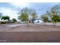 Front yard view of a one-story house with trees at 6118 N 183Rd Ave, Waddell, AZ 85355