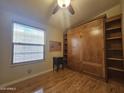 Bedroom with wood floors and a built-in Murphy bed at 650 N Hawes Rd # 4820, Mesa, AZ 85207